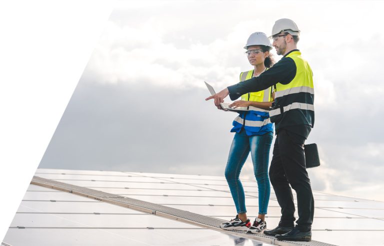 Roofers using roofing estimate software on a laptop